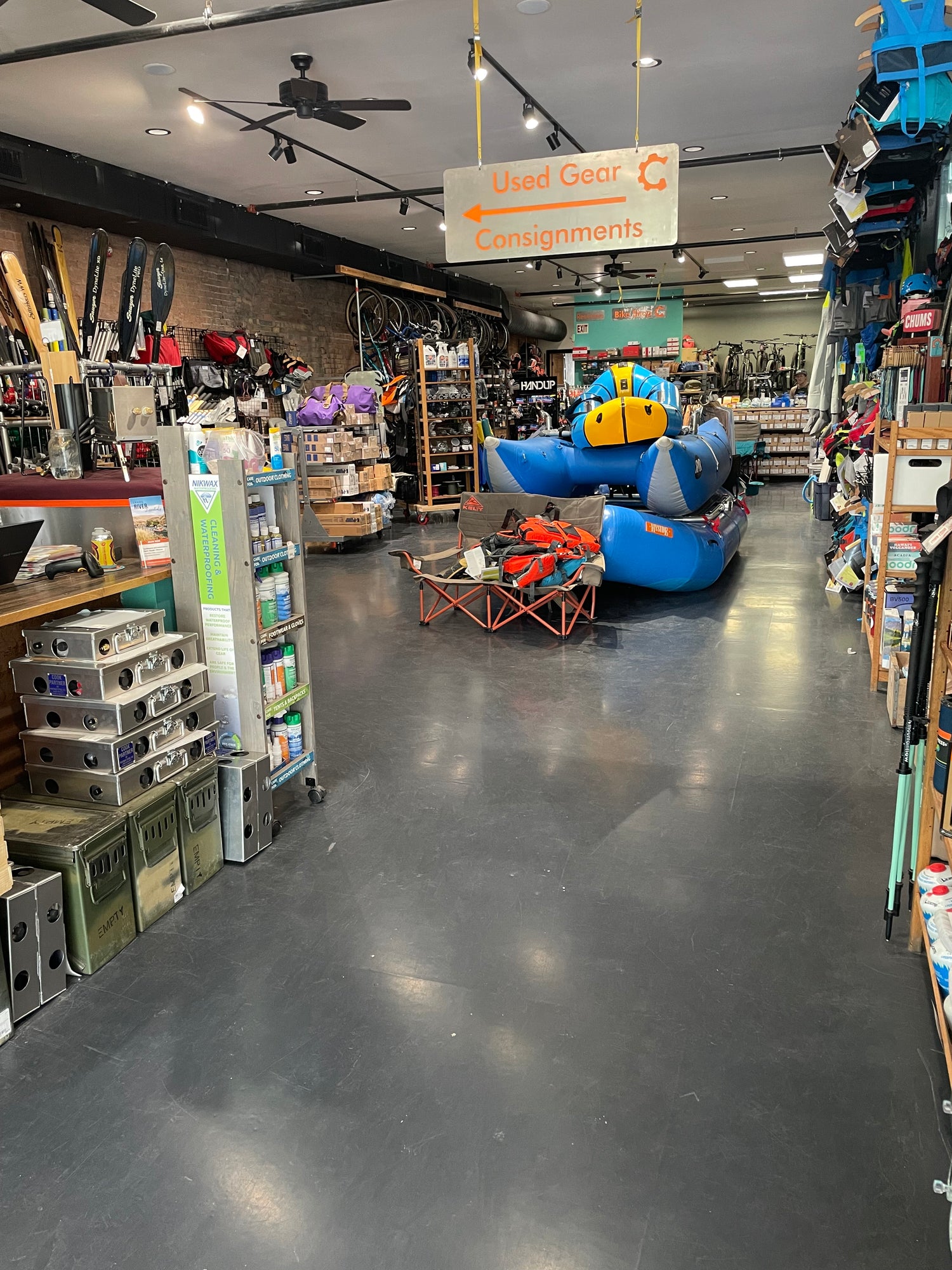 River rafts, outdoor gear, and a used gear sign inside the Gear Junction shop in Downtown Grand Junction, Colorado